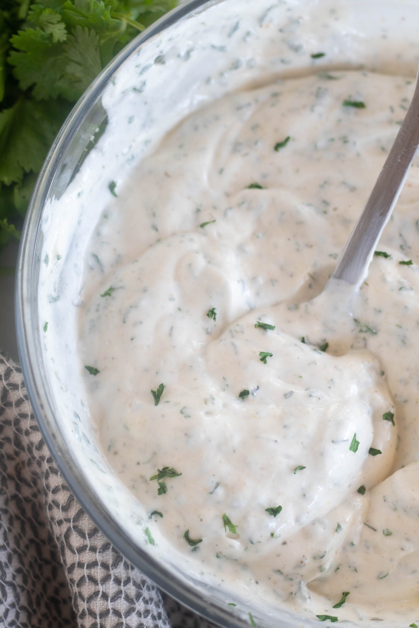 close up of ranch dressing in a bowl with a spoon