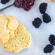 cut biscuit on parchment paper with berries