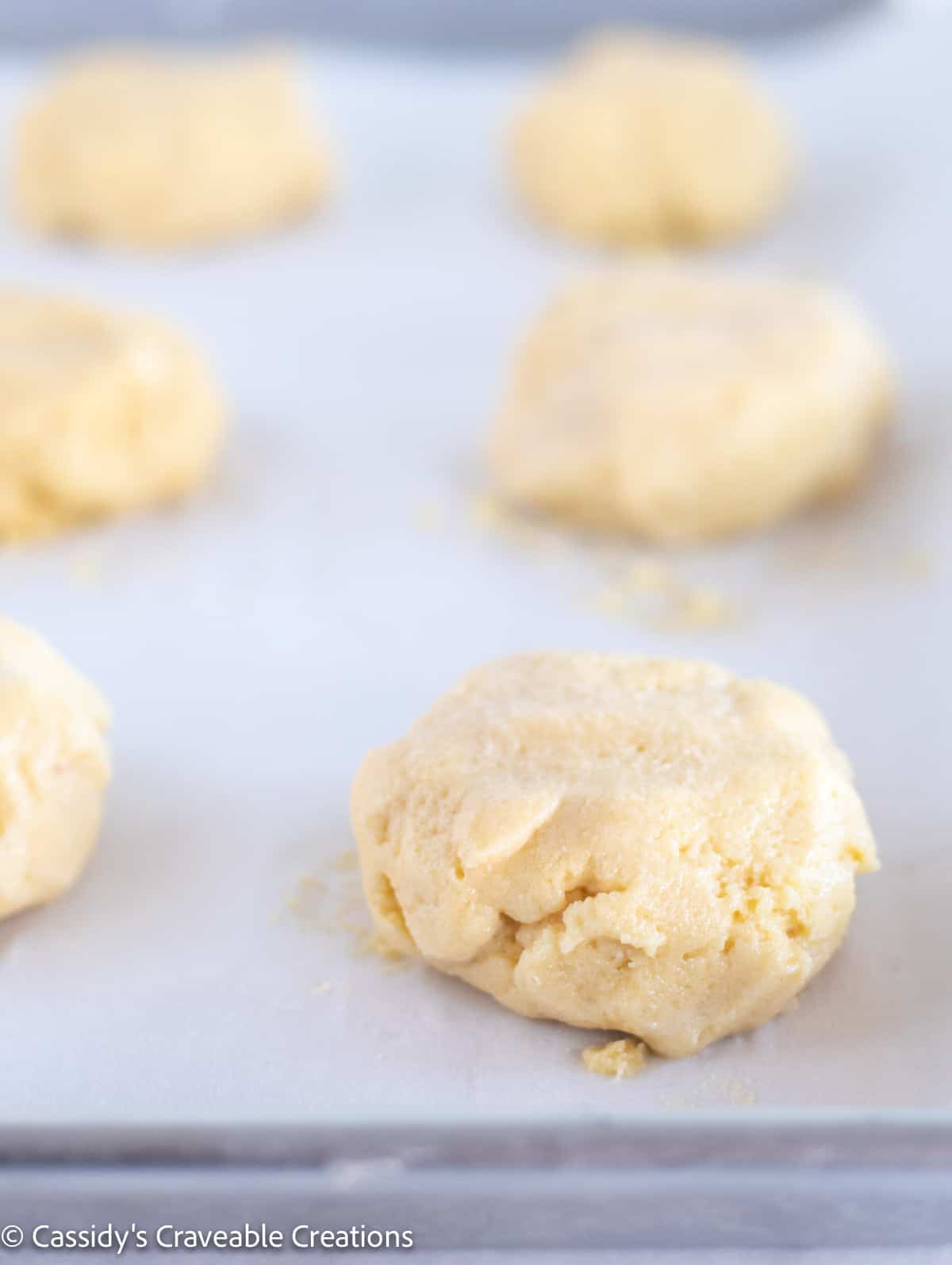 unbaked biscuits on baking sheet.