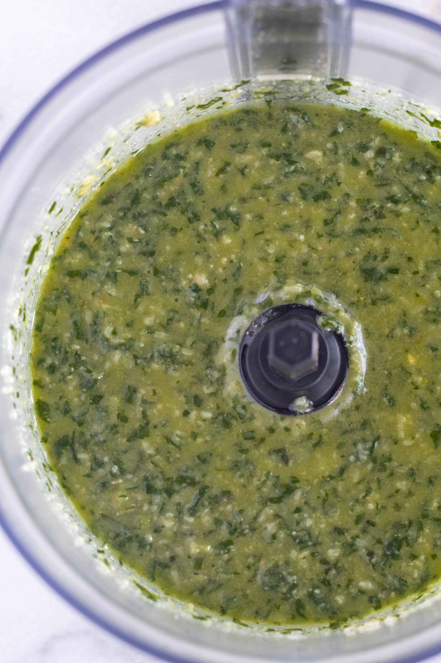 Blended pesto in the bowl of a food processor.
