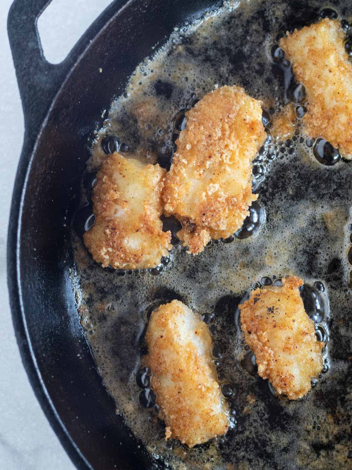 frying fish in a cast iron skillet