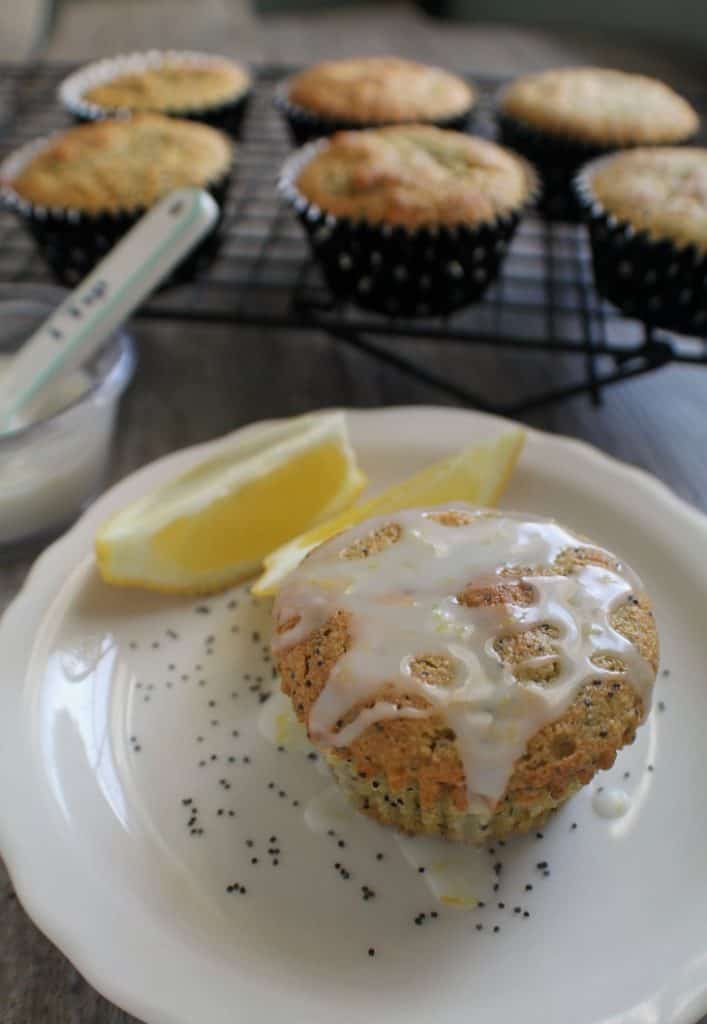 muffin on a plate with glaze and lemons