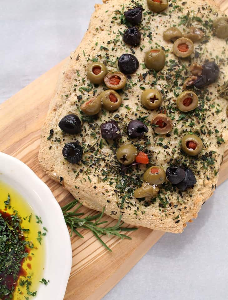 olive focaccia bread on cutting board