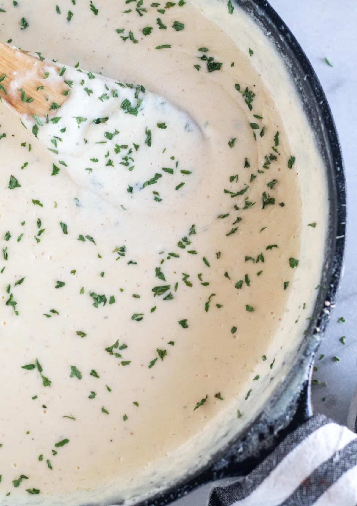 alfredo sauce in a cast iron skillet