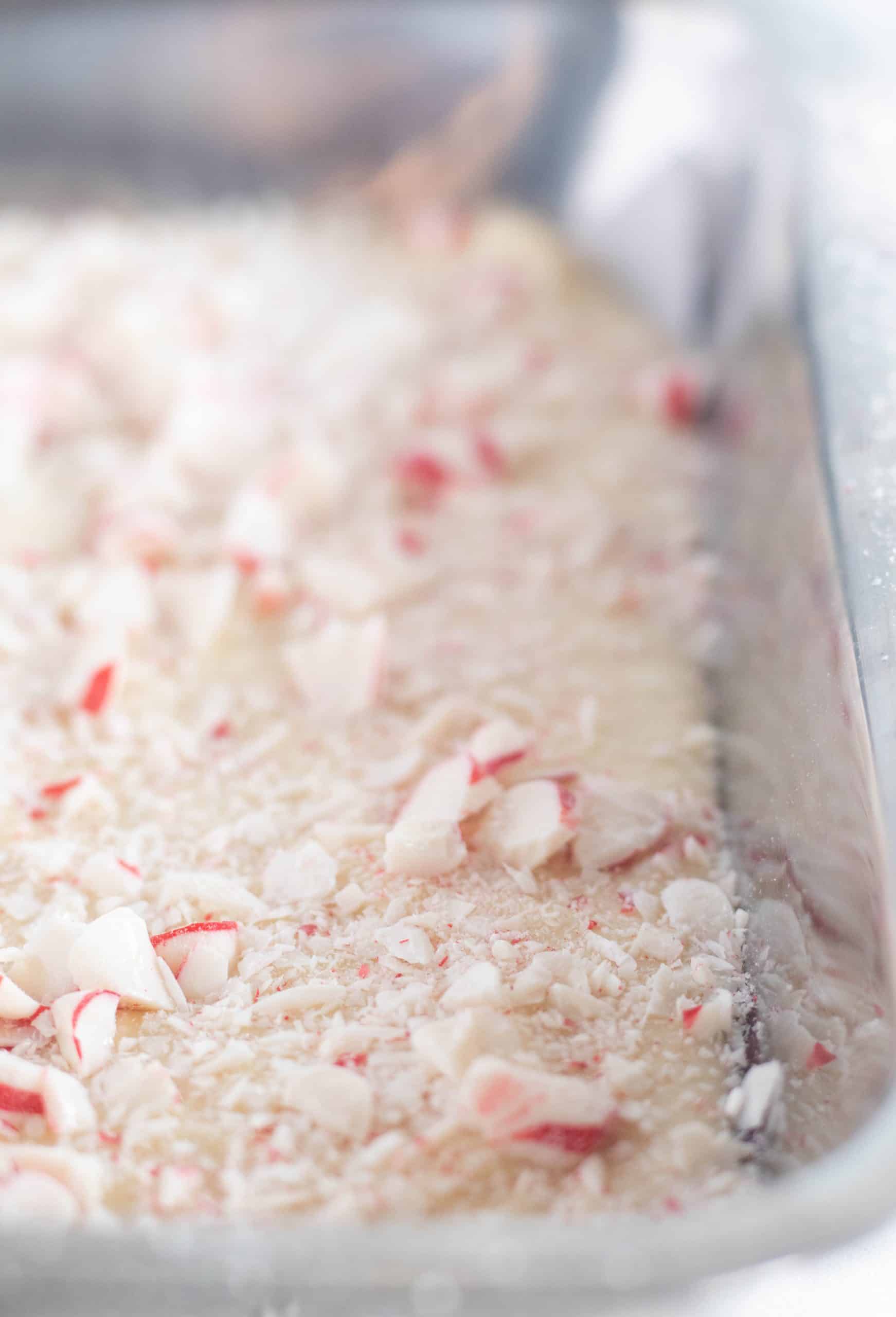 close up of crushed peppermints over the white chocolate