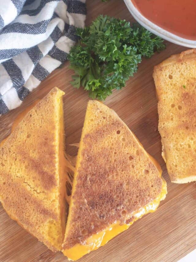 grilled cheese cut in half on a cutting board
