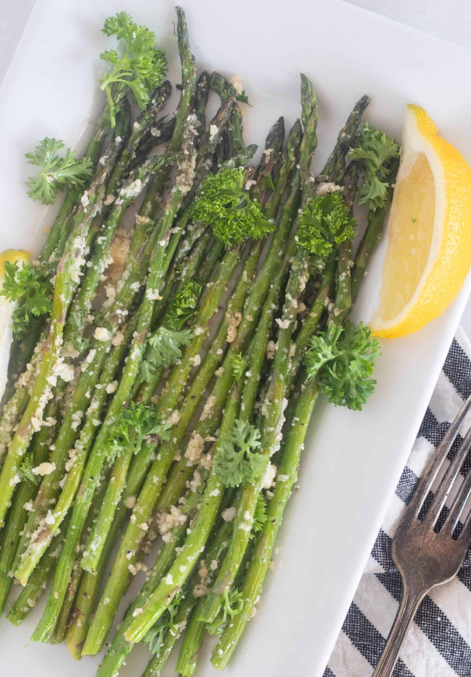 asparagus on a white plate with a fork