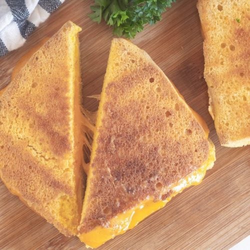 cut grilled cheese on cutting board