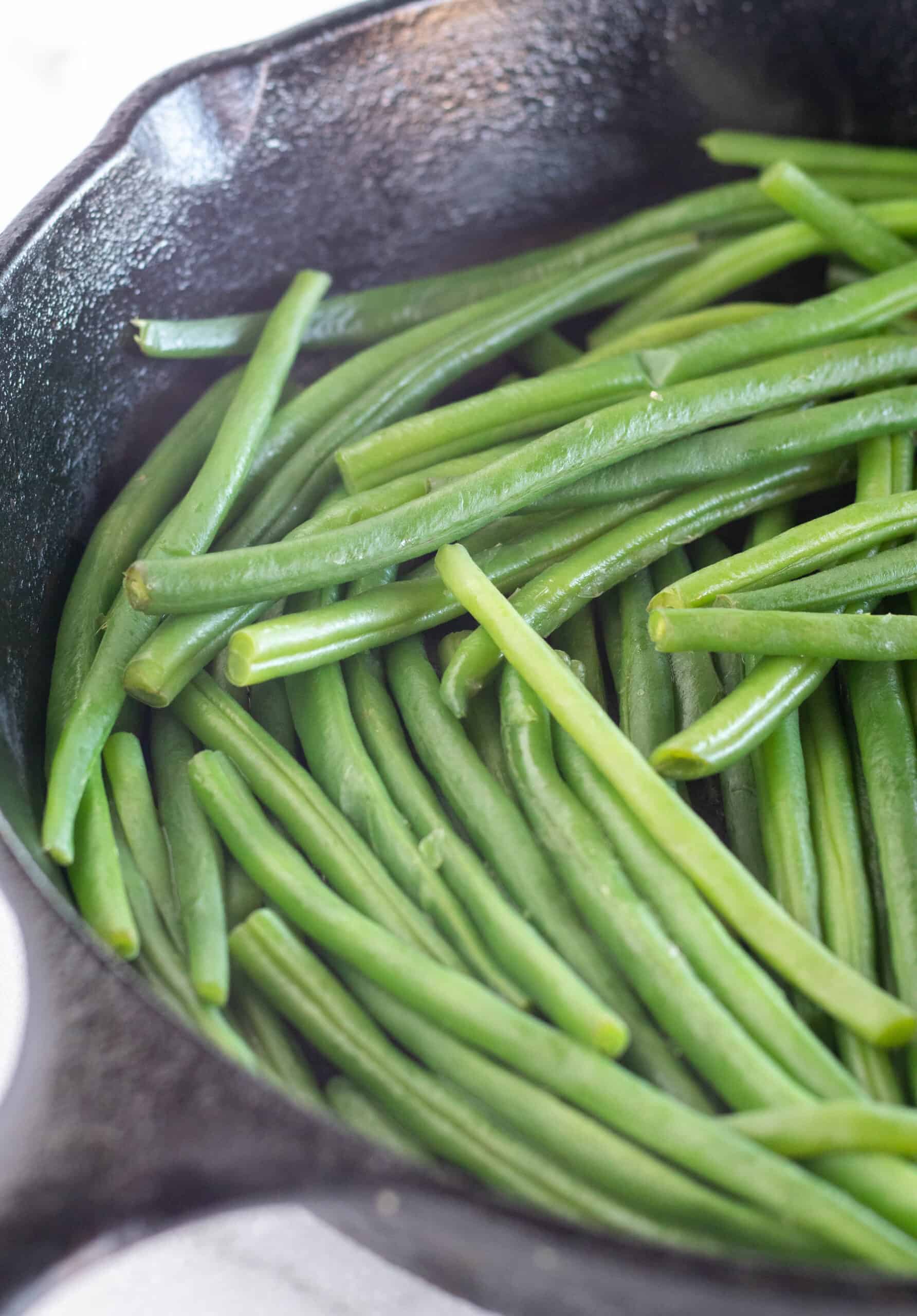 cooked green beans in skillet.