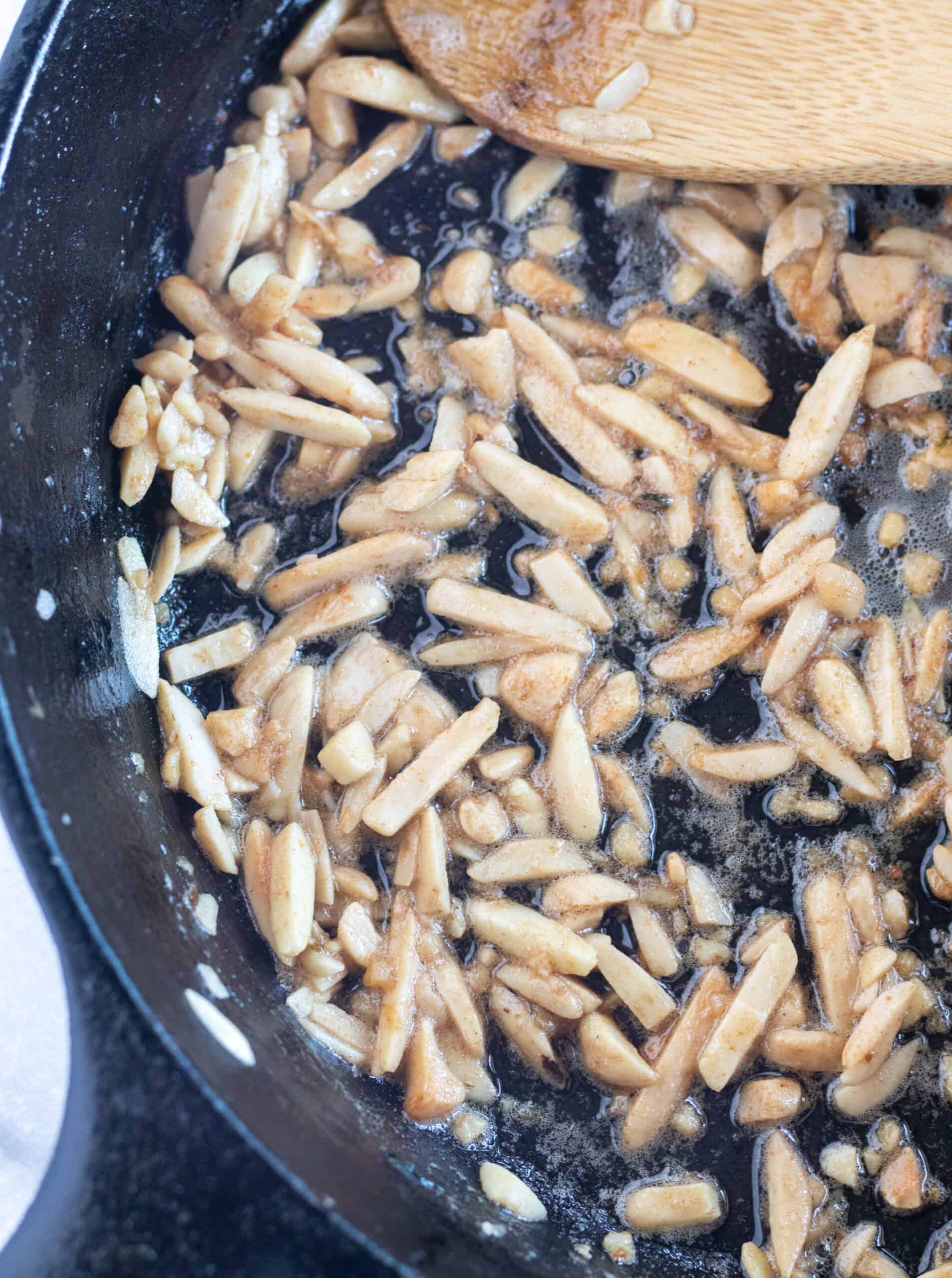 toasted almonds in cast-iron skillet