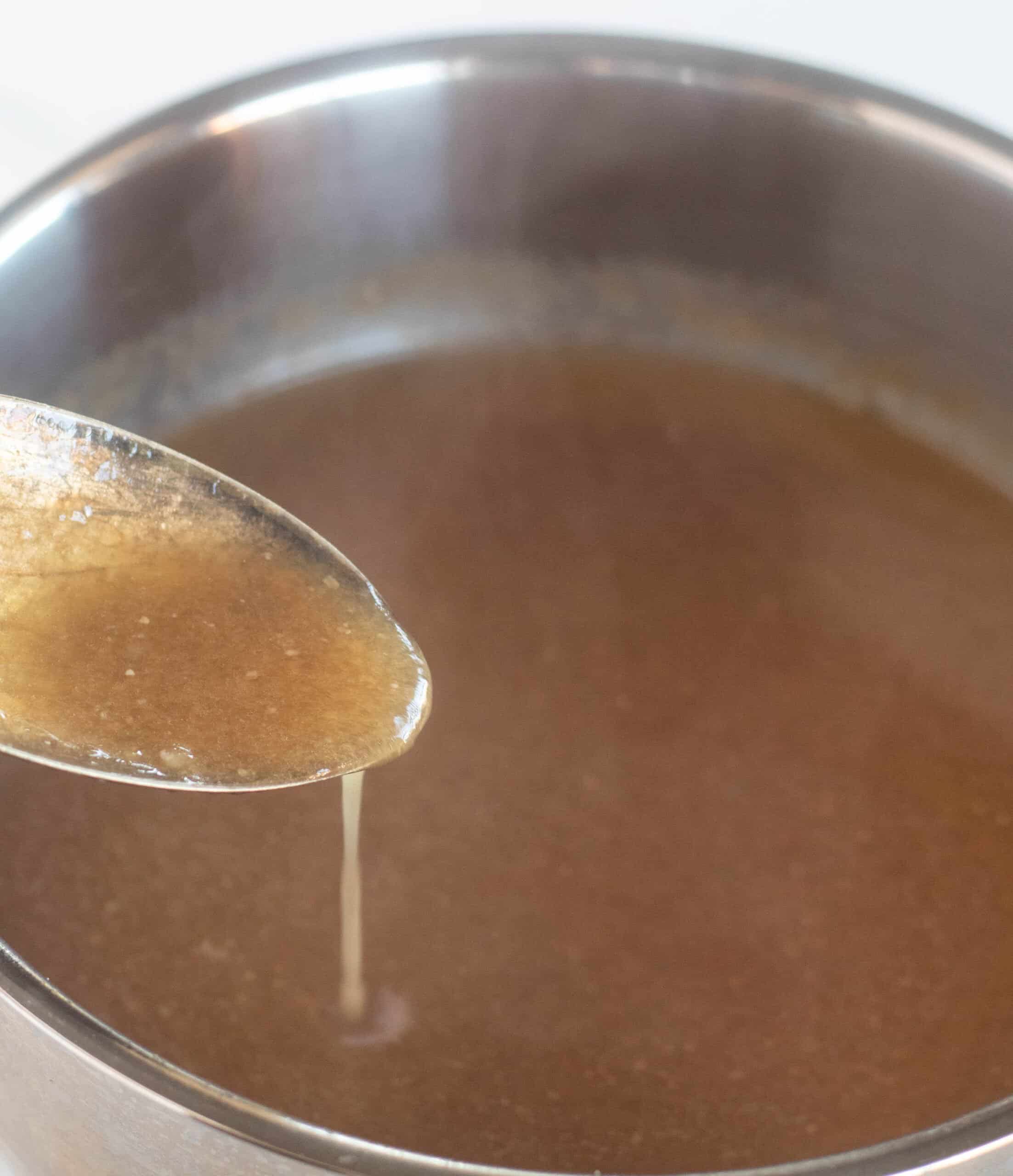 scooping a spoonful of keto gravy