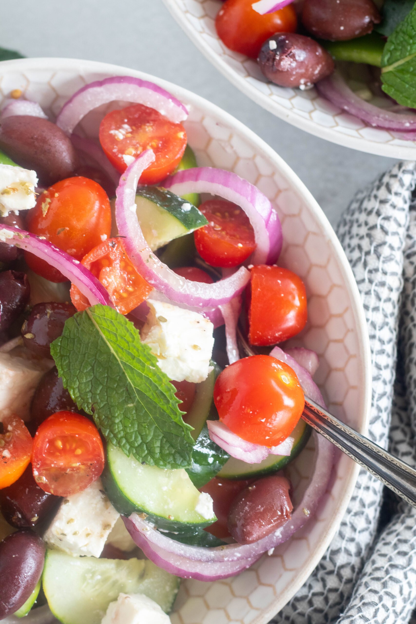 close up of finished greek salad in a bowl