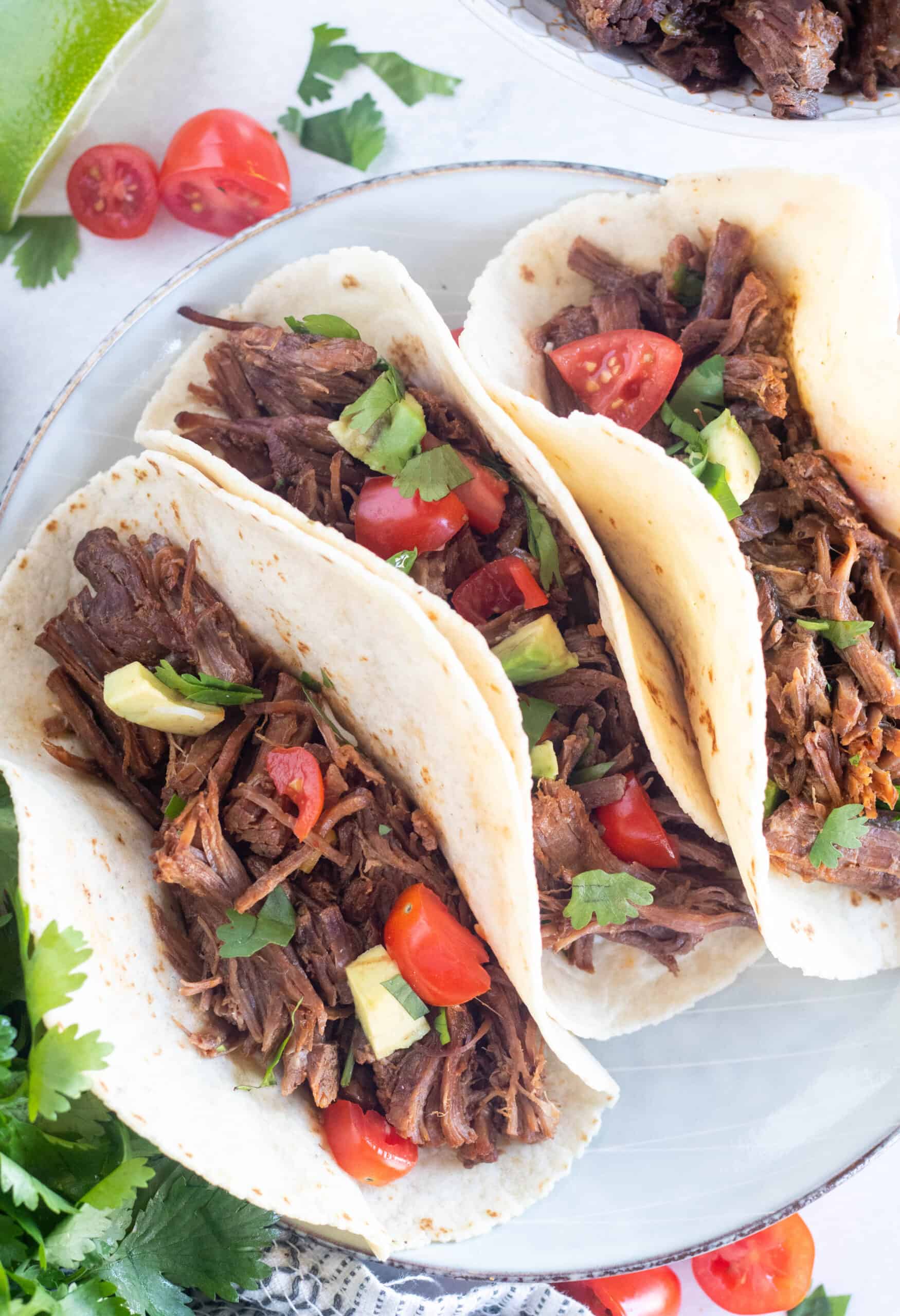 close up of shredded beef tacos.