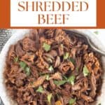 shredded beef in a bowl with the name of the recipe at the top.