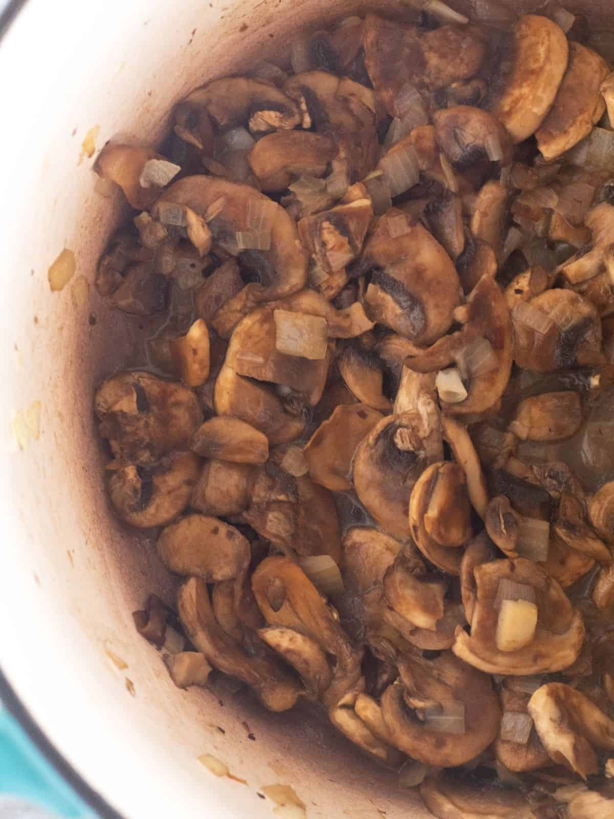 sauteed mushrooms and onion in pot.