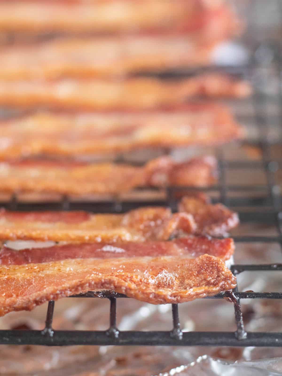 close up of cooked bacon on a cooling rack.