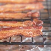 square image of cooked bacon on a cooling rack.