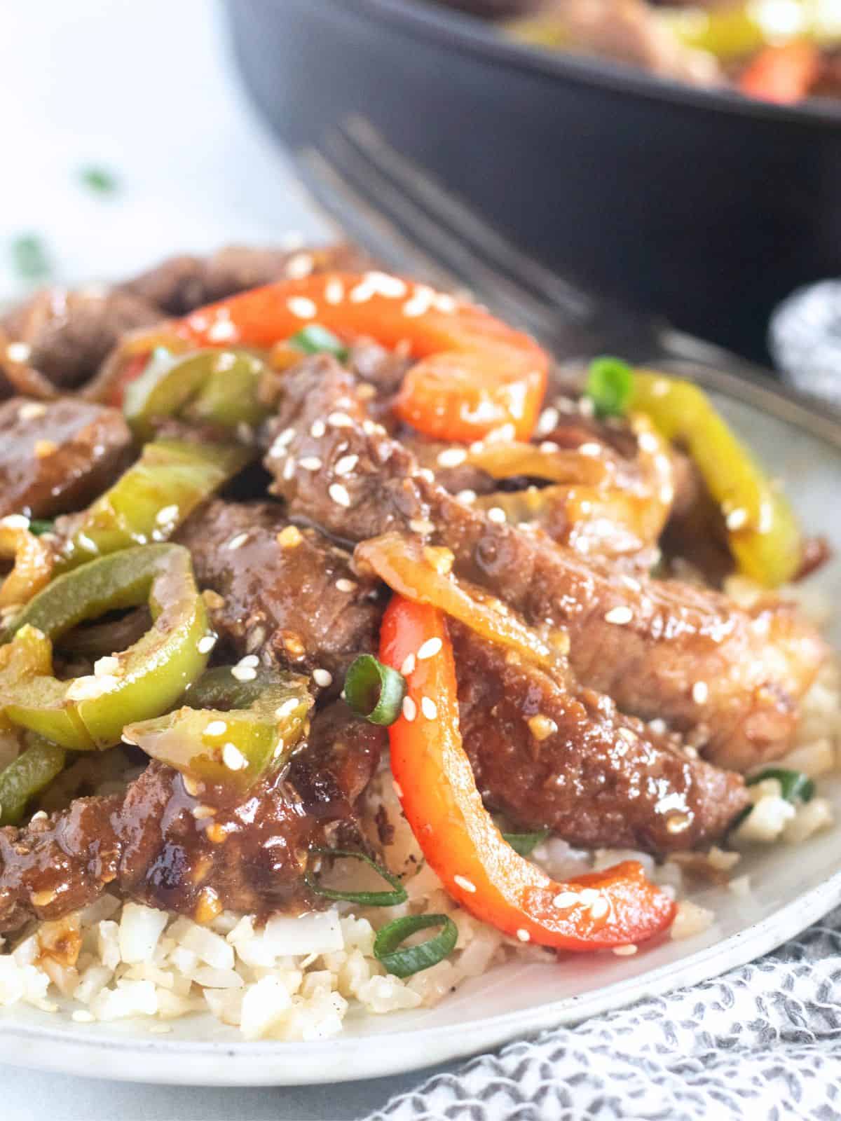 close up of low-carb pepper steak over cauiflower rice.