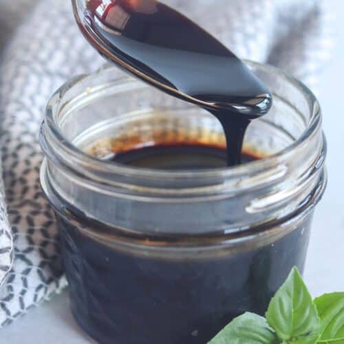 close up of balsamic glaze on a spoon.