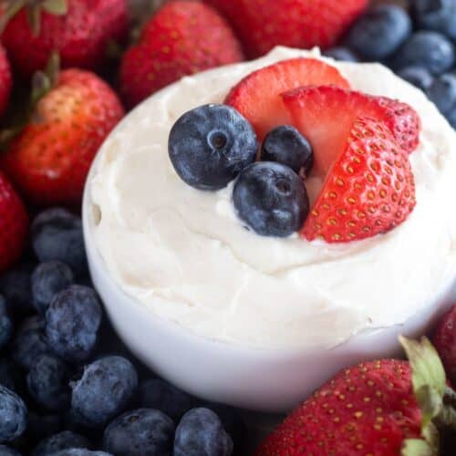 square image of fruit dip with berries on top.