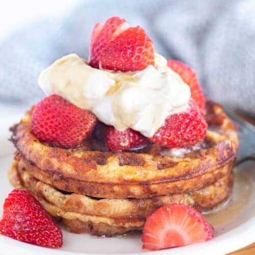 square image of chaffles with berries and cream.