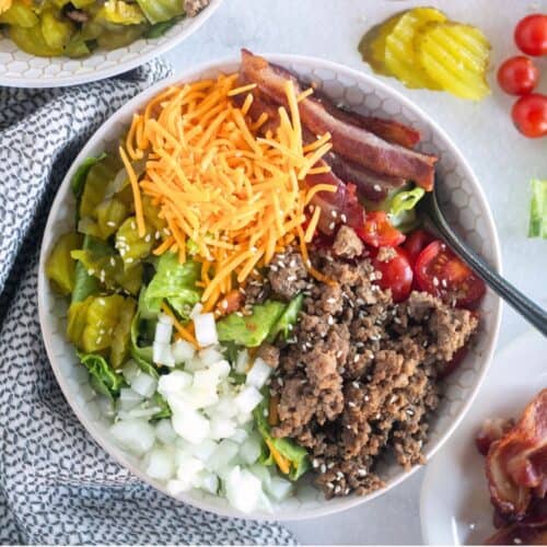 square image of cheeseburger bowl with garnishes.